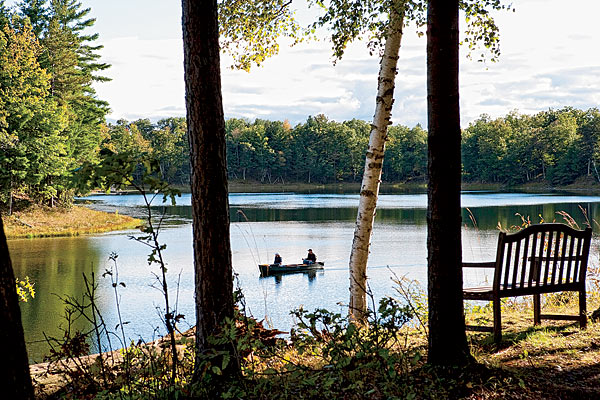 Some of the attractions at posh Canoe Bay: Prairie-style architecture in harmony with the landscape, canoeing, fishing (shown here), and hiking.