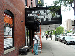 Workers changing the marquee