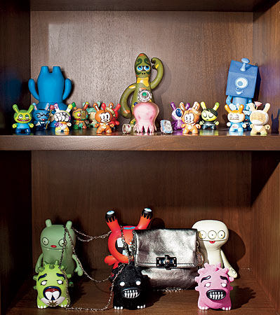 A Lanvin shoulder bag tucked into a lineup of designer figurines