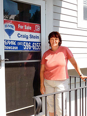 Christine O'Malley in front of her house
