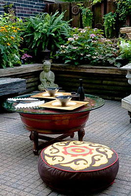 An Asian-themed table setting, surrounded by a garden