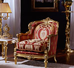 An elaborately designed red Italian armchair, trimmed in gold