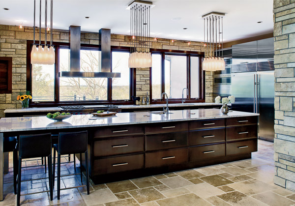 A drywalled structural column anchors the eight-foot-long L-shaped island that Bill Rodon-Hornof of 2RZ Architecture created in this Lincoln Park condo.