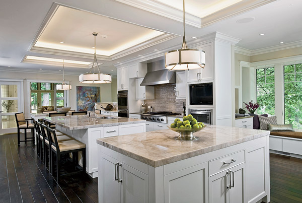 T﻿his Beverly kitchen designed by Barbara Ince and Sarah Davis of Susan Fredman Design Group has three quartzite-topped islands lined up below ceiling cutouts that mimic their shape and size