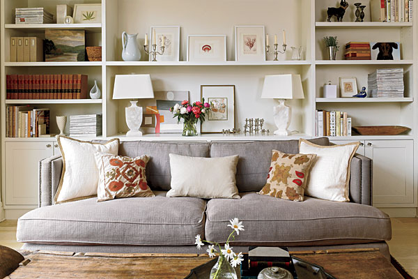 The kitchen morphs into a family room, with continuous built-in cabinets guiding the eye from one space to the other. The sofa, from Jayson Home & Garden, is set right up against them.