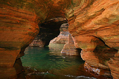 Sandstone sea caves can be toured via chartered cruise or explored solo
