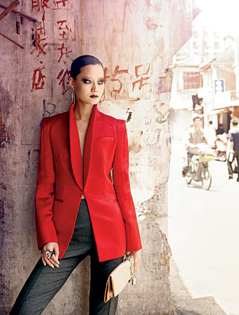 WES GORDON blazer and pants, JIMMY CHOO clutch, OBJETS D’ENVY ring, and PAIGE NOVICK earrings