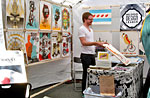 An artist displaying his work at the Renegade Craft Fair