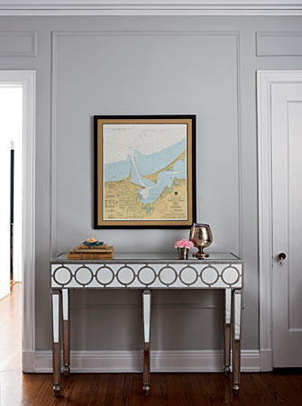 Sometimes all you need is one compelling piece of furniture, such as this Art Deco–inspired mirrored console, to make an entryway come to life. Another great idea: If expensive large-scale art is out of the question, hang a vintage map—it’s timeless, classy, and easy.