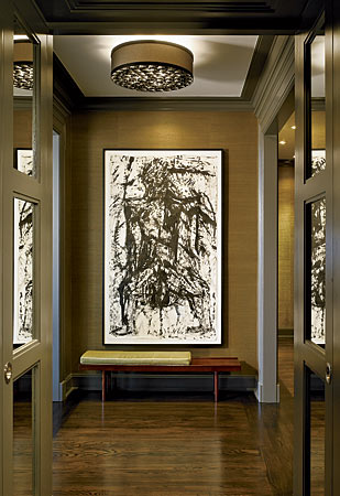 Talk about setting the tone for the rest of the home—a gallery-like entryway is a perfect introduction to the elegant mix of mid-century antiques, edgy art, and belle époque architectural detail that fills this Gold Coast apartment.