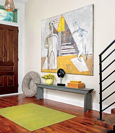 An entryway is a great place for an eye-catching work of art. In this North Side home, a painting by Jeff Kruse anchors the space and also provides a hint of the citrusy color scheme that brightens the rest of the house.