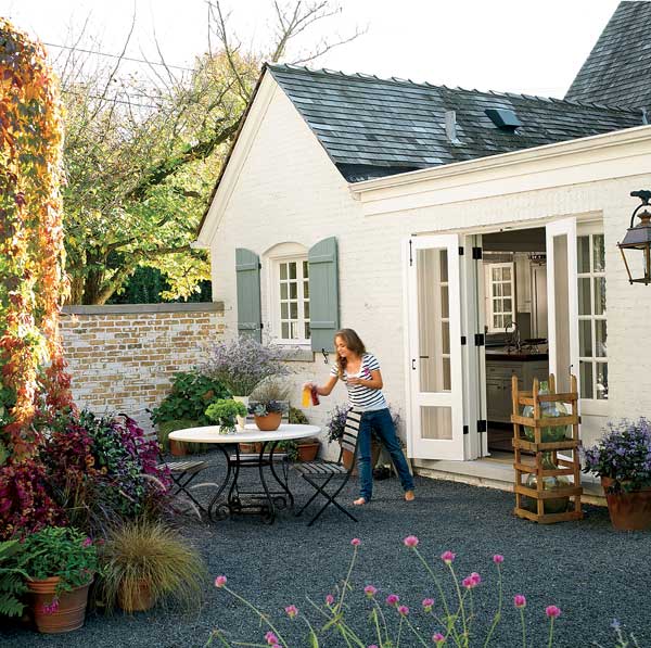 The Ponterios' daughter brings drinks to the family dining area, paved with crushed stone, just outside the kitchen. Antique wine jugs, in their original crates, are gradually filling up with corks.