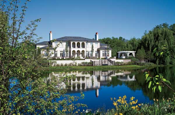 The back of the Italianate-style house overlooks a man-made pond, which landscape architect Sara Furlan edged with native wetland plants. She seeded the sloped shoreline with no-mow fescue grasses.