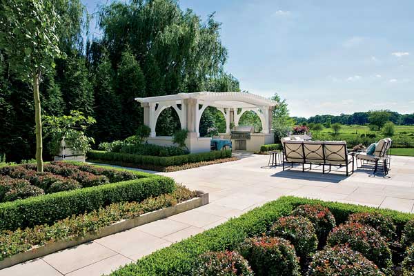 A pergola at one end of the yard balances the swimming pool at the other. 