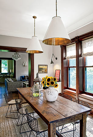 A vintage table from Architectural Artifacts was cut down to fit the breakfast room in this Highland Park home. Bertoia chairs and crisp-lined pendant lamps keep the mood light.