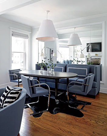 Designer Todd Haley hung an oversize lampshade from CB2 for “tension and excitement” in a sophisticated Lincoln Park dining area and balanced it with upholstery in a calming lavender hue. “I showed the client only one fabric,” Haley says of the Knoll textile he used for the chairs and the banquette.