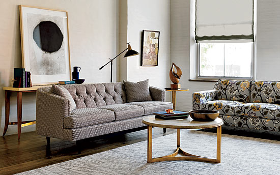 Antoine console in parchment and vintage brass, Chester three-seat sofa (left), Milo cocktail table in travertine and antique gold, and Larkin three-seat sofa