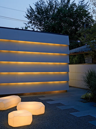 Lights inside Dan Wheeler garage automatically turn on at dusk. Polyethylene boulders glow in the rock garden.