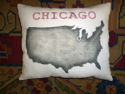 A pillow with a map of the US, marking Chicago