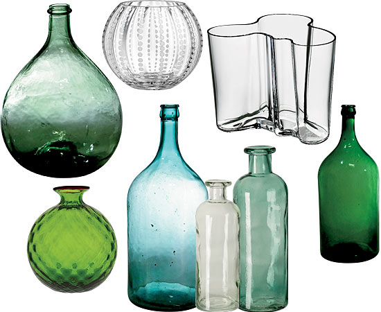 Antique olive jar, Kiki vase, $13, at Crate & Barrel. Iittala Aalto vase, $95, at Bloomingdale’s. Antique wine bottles, $380 each, at Golden Triangle, flanking recycled glass jugs, $19 and $29, at West Elm. Venini small Balloton vase