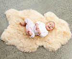 A baby on a fluffy rug from Sprout