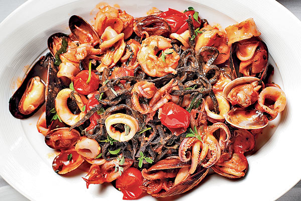 Piccolo Sogno Due’s squid ink spaghetti, tomatoes, and shellfish