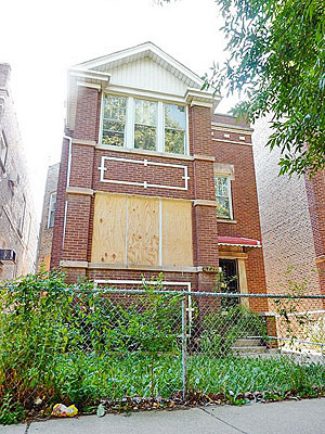 A boarded-up foreclosed home