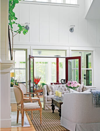 A three-season porch across the back of the house shades the living room; clerestory windows and skylights bring in soft natural light. 