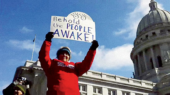 Walker’s bill to effectively curtail union rights spurs massive protests and leads to the state’s first ever gubernatorial recall election.