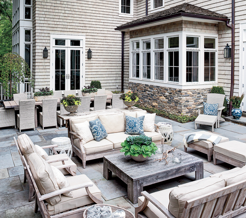 The family loves spending time on the large bluestone terrace in the backyard. 