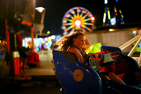A girl riding the Sizzler at the Illinois State Fair