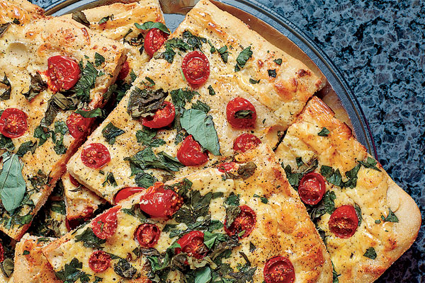 Pizza with ricotta, grape tomatoes, and fresh herbs