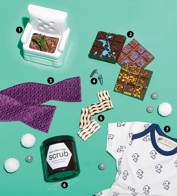 Ceramic planter, milk and dark chocolate bar flights, silk bow tie, quartz earrings, maple ply domino set, Dark Matter Coffee body scrub, and a Little Goat cotton and Lycra onesie