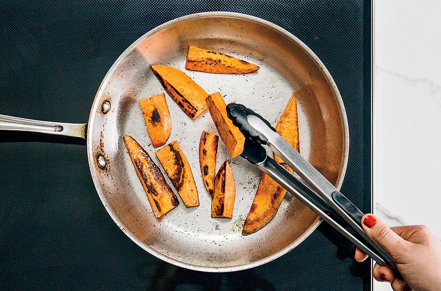 Sweet potatoes frying in a pan