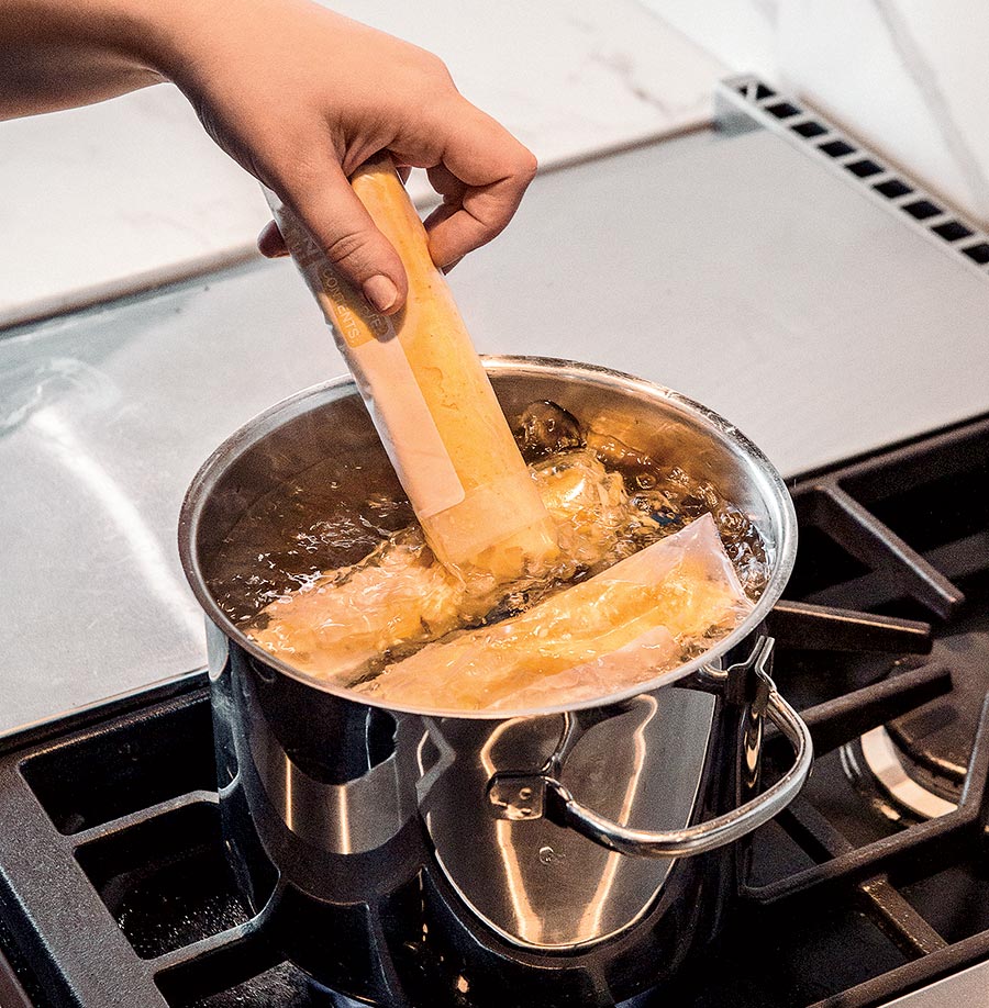 Bagged eggs boiling in a pot