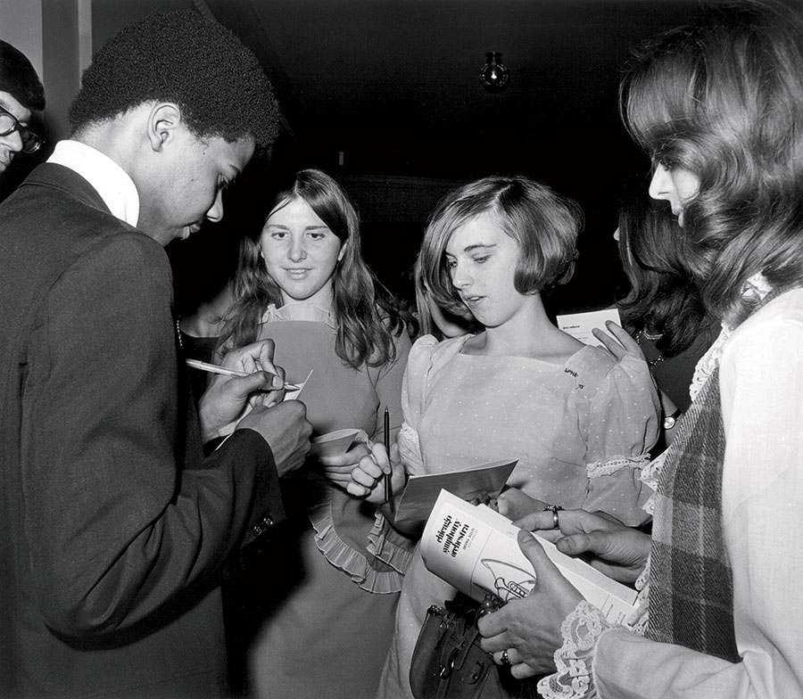 Signing autographs after the debut of his work with the orchestra in 1970.