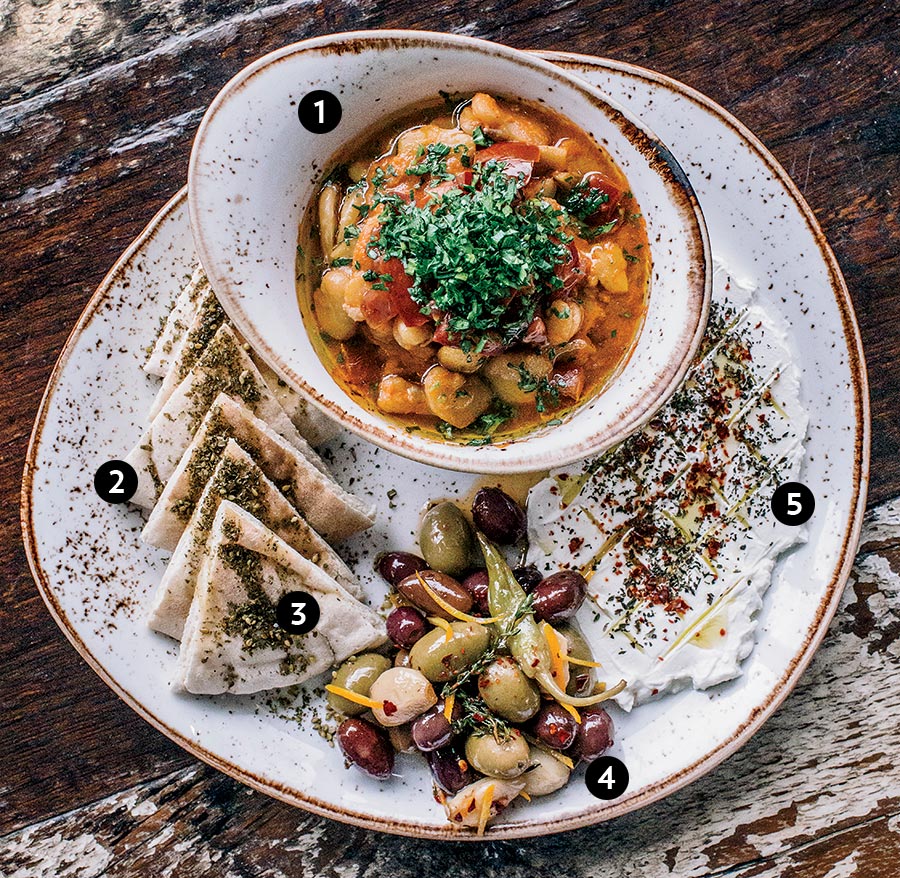 Ful medames, pita, za’atar, olives, and labneh