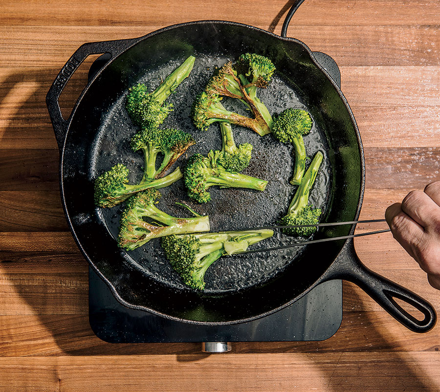 Tossing broccoli in a skillet