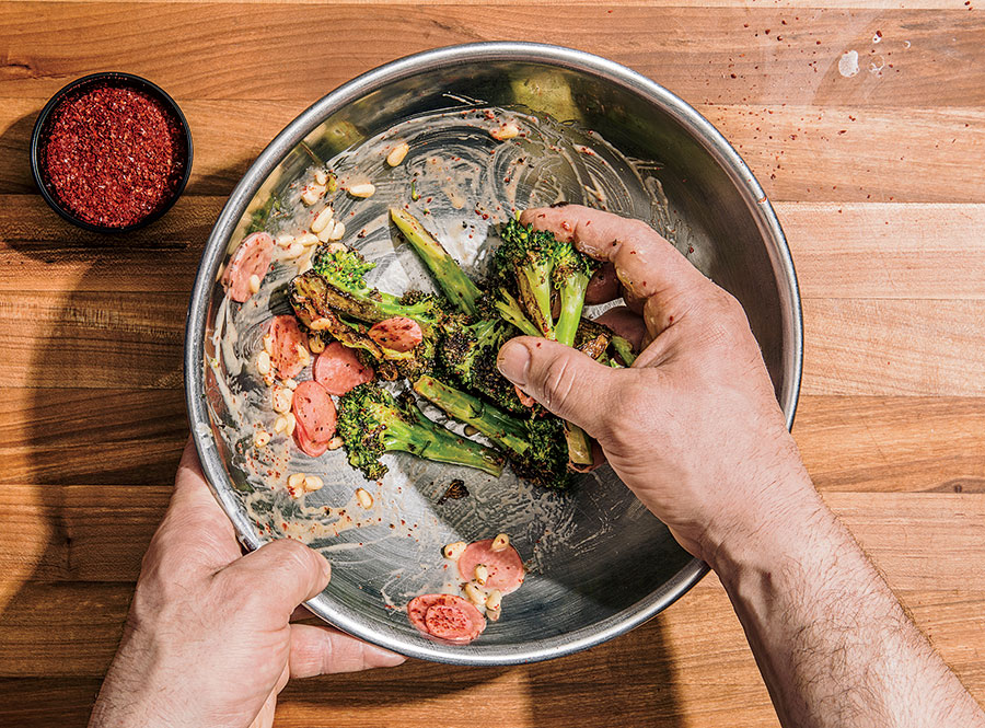 Tossing broccoli and radishes with the mixture