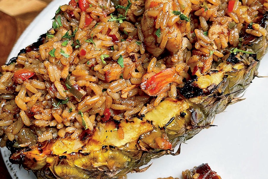 Pineapple bowl with jerk shrimp and chicken fried rice at Caribbean Jerk Palace