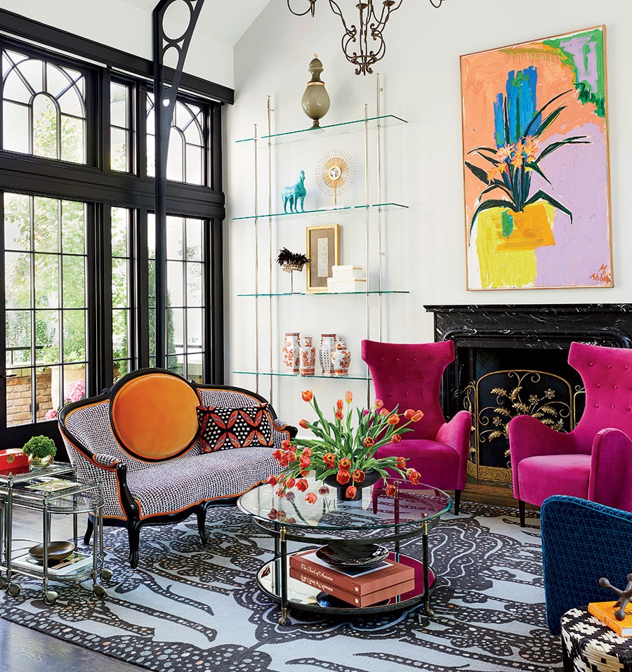 “Pink, blue, fuchsia, orange, teal — we wanted an explosion of color,” says the homeowner of the living room’s bold palette.