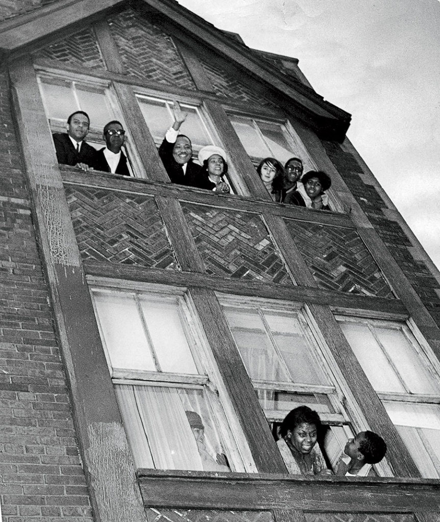 King, with his wife, Coretta, waves to a crowd after moving into an apartment at 1550 South Hamlin Avenue in 1966.