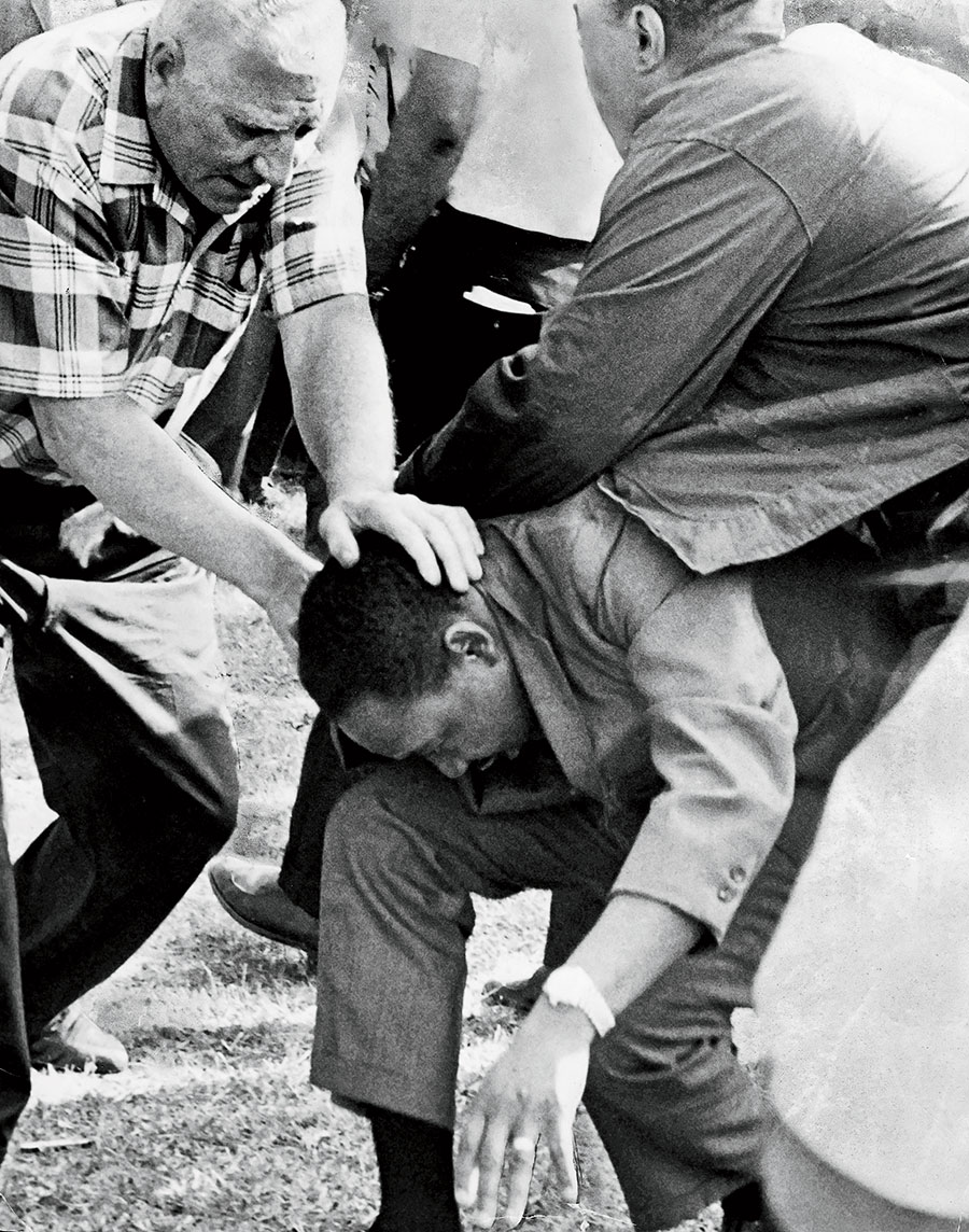 Aides shield King after he was struck by a rock during an August 5, 1966, march in Marquette Park in Chicago.