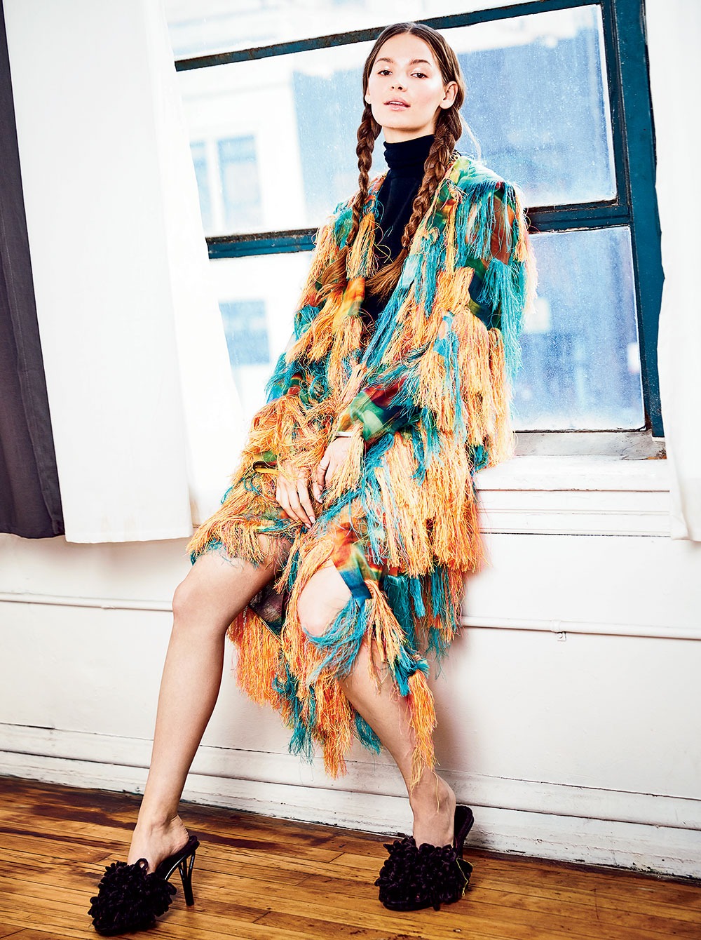 Dries Van Noten fringe coat, knit turtleneck, and Bottega Veneta viscose mule sandals