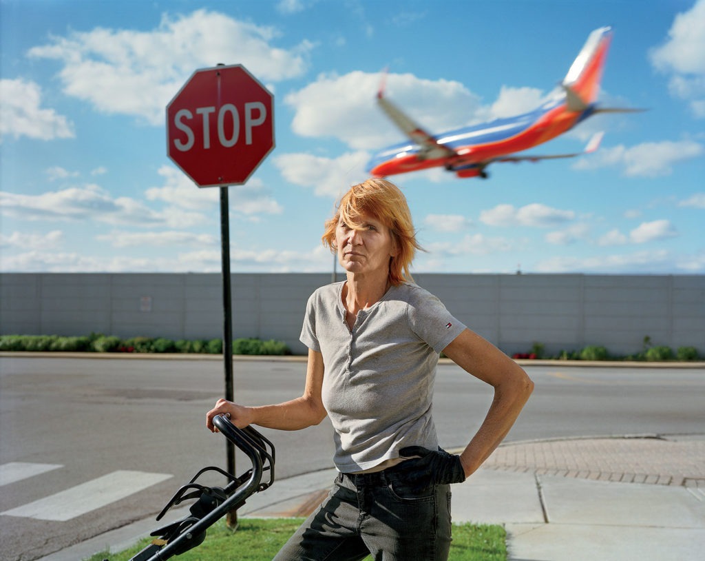 A woman mowing the lawn outside Midway Airport