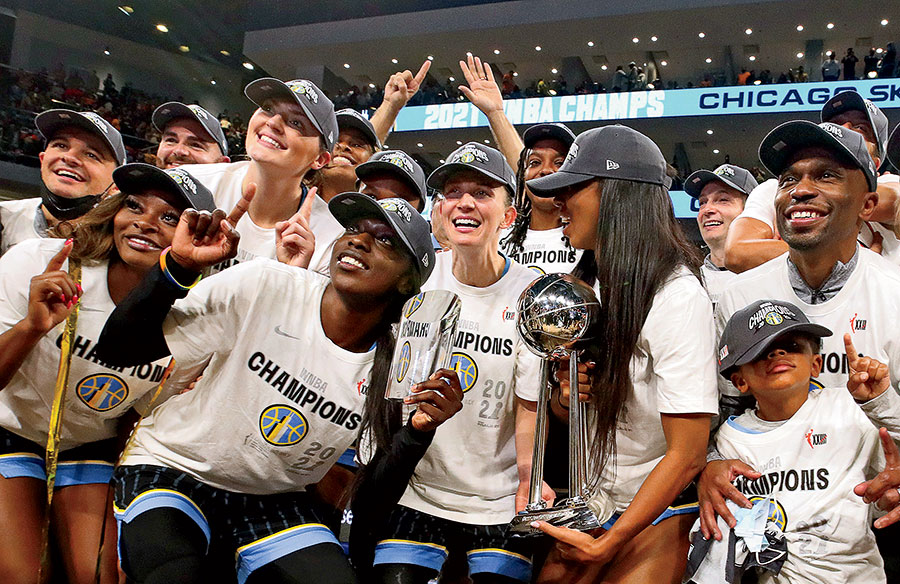 Kahleah Copper posing for a photo with her team after their championship win.