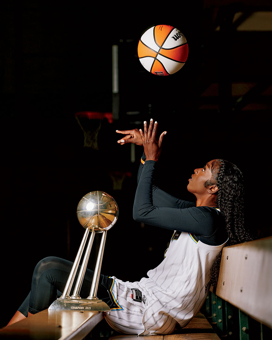 Kahleah Copper with her trophy, tossing a basketball