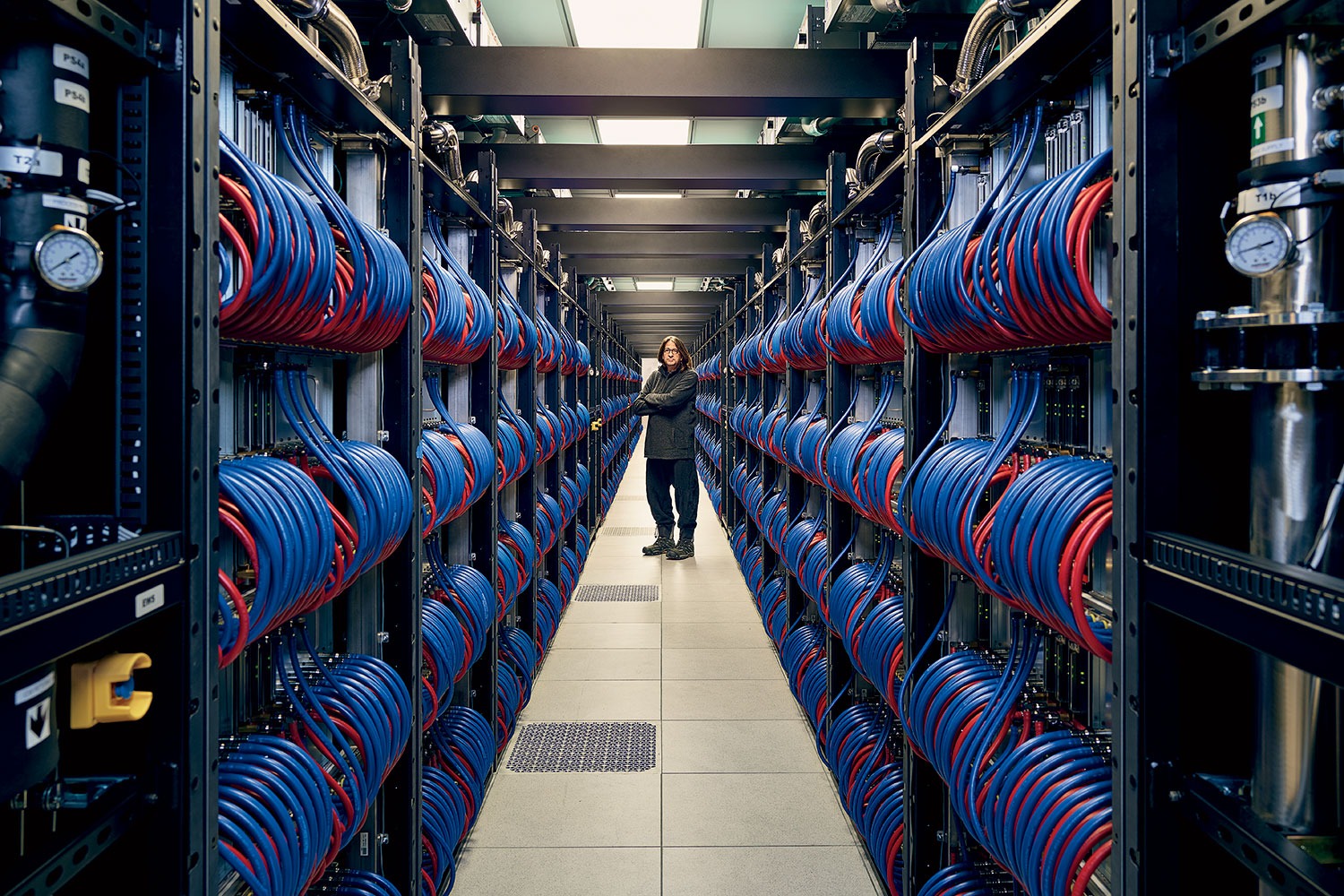 Rick Stevens standing in the room housing the supercomputer nodes.