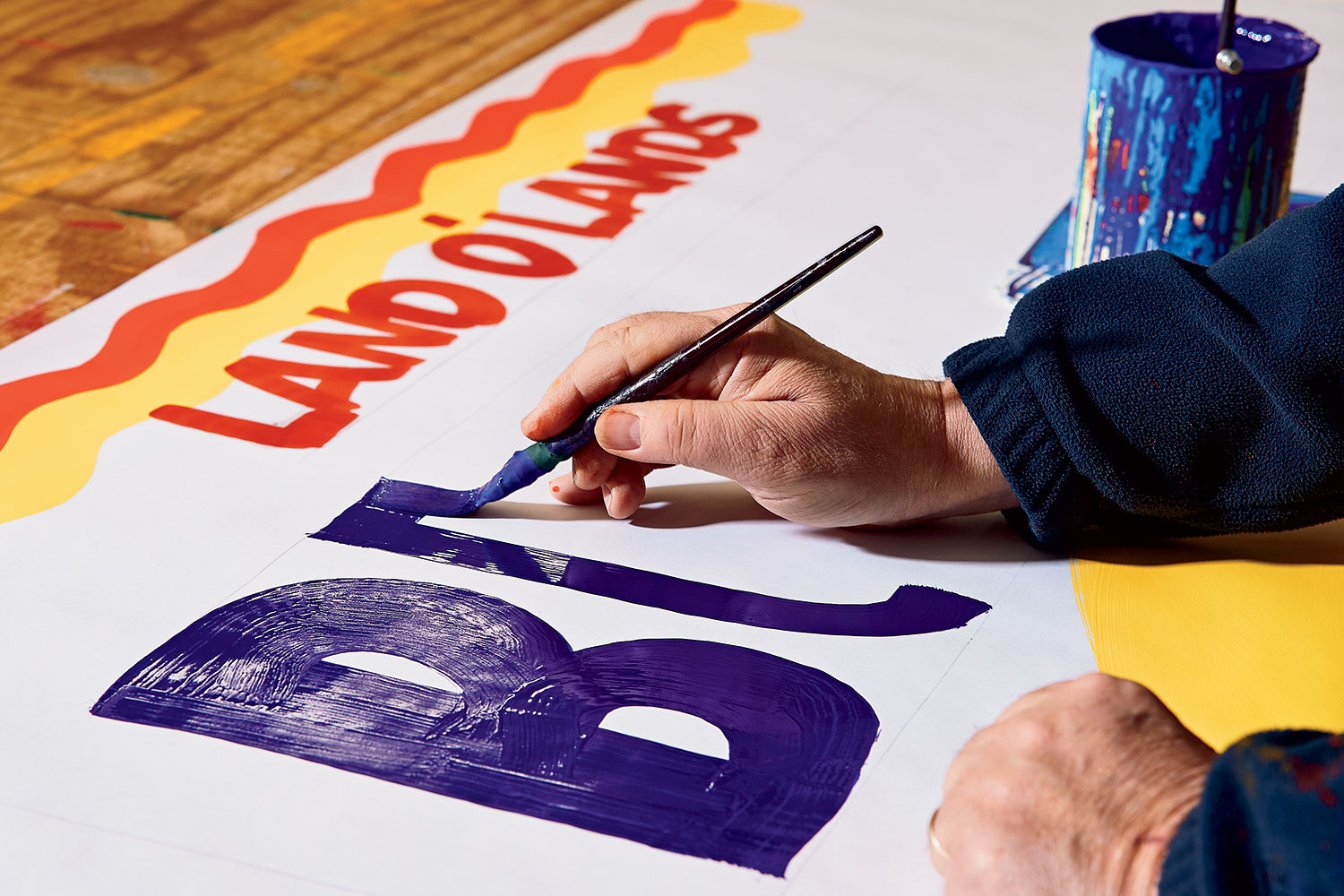 A grocery sign being painted.