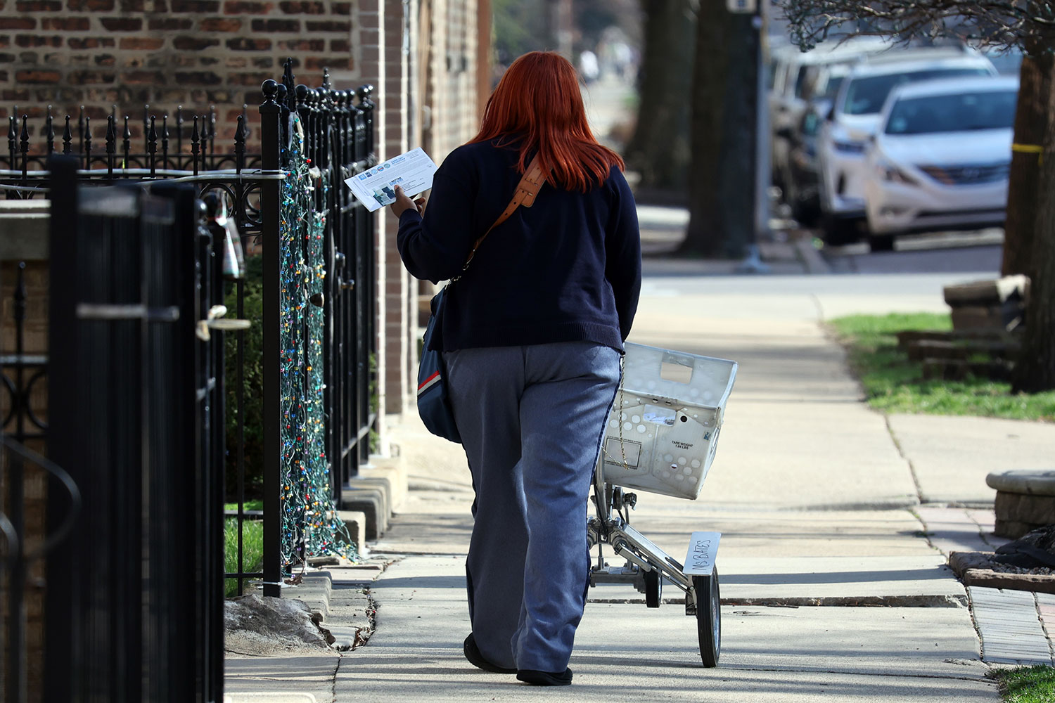 A mail carrier making her rounds.